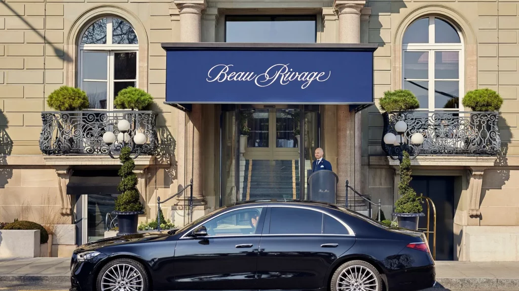 Chauffeur waiting for clients at Beau Rivage Geneva for a private transfer